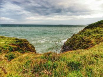 Scenic view of sea against cloudy sky