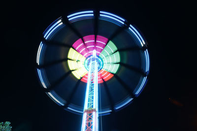 Low angle view of illuminated ferris wheel at night