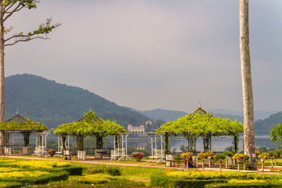 Built structure by lake against sky