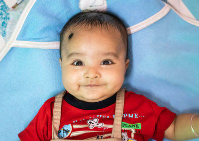 Cute infant facial expressing from top angle indoor shot
