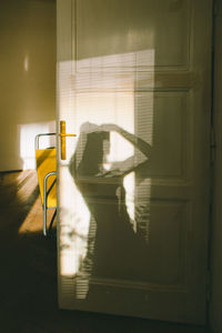 Shadow of man sitting on seat at home