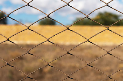 Full frame shot of chainlink fence against sky