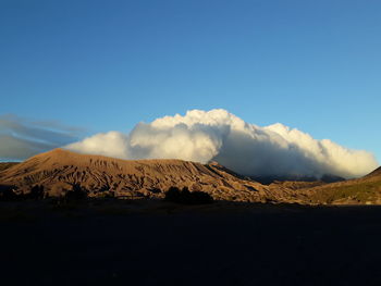 Scenic view of mountains against clear blue sky