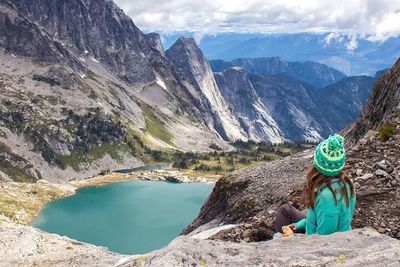 Rear view of man hiking on rocky mountain