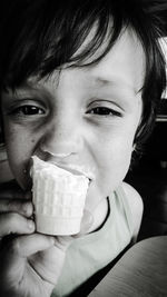 Close-up portrait of boy eating ice cream