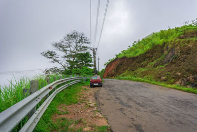 Cars on road against sky