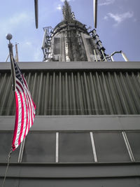 Low angle view of flags against sky