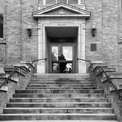 Low angle view of man walking on staircase of building