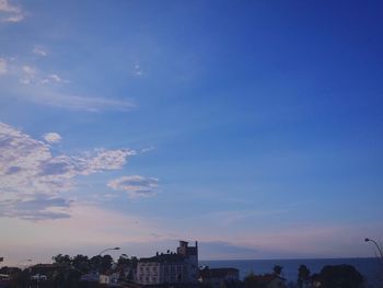 Buildings in city against sky during sunset