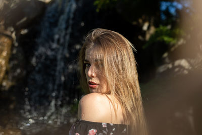 Portrait of woman against blurred background