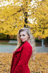 Portrait of young woman with autumn leaves