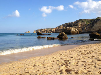 Scenic view of sea against cloudy sky