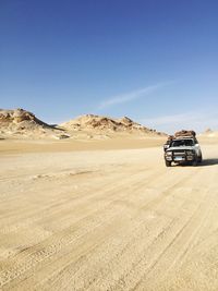 View of car on desert land