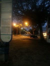 Cars on illuminated street at night