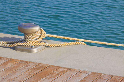 High angle view of rope tied on pier