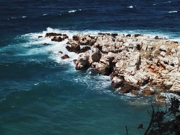 High angle view of rock formation in sea