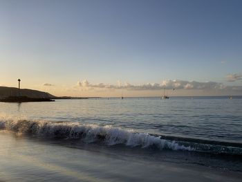 Scenic view of sea against clear sky during sunset