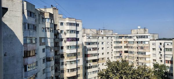 Low angle view of buildings against blue sky