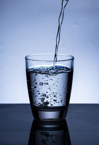 Close-up of drink in glass against white background