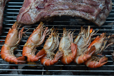 High angle view of meat on barbecue grill