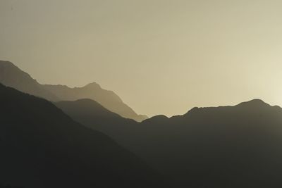 Scenic view of silhouette mountains against clear sky