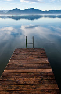 Jetty in lake against sky