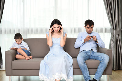 Young couple sitting on sofa at home