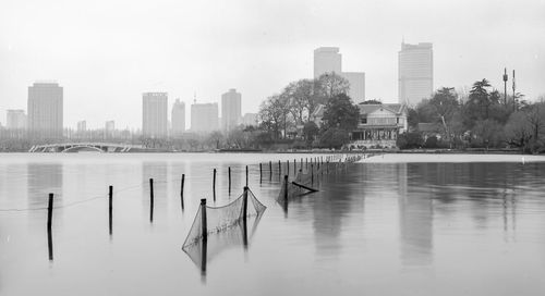 City by river against sky