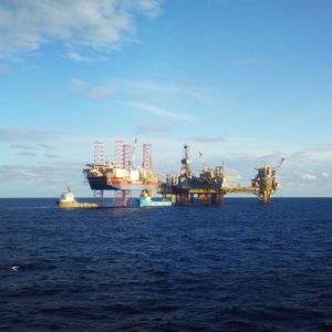 Commercial dock by sea against sky