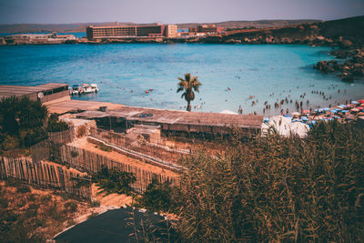 High angle view of sea and buildings against sky