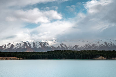 Gloomy landscape of new zealand southern alps and lake pukaki with blue sky and clouds.