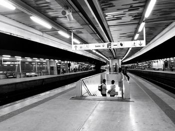 People waiting at railroad station platform