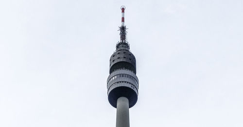 Low angle view of communications tower against sky