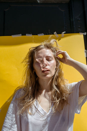 PORTRAIT OF WOMAN WITH YELLOW EYES IN BACKGROUND