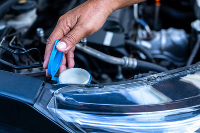 Cropped hand of man repairing car