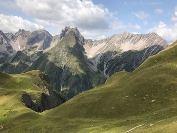 Scenic view of mountains against cloudy sky