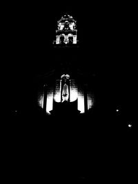 Low angle view of illuminated lamp at night