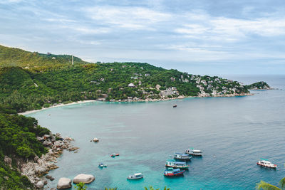 High angle view of boats on sea shore against sky