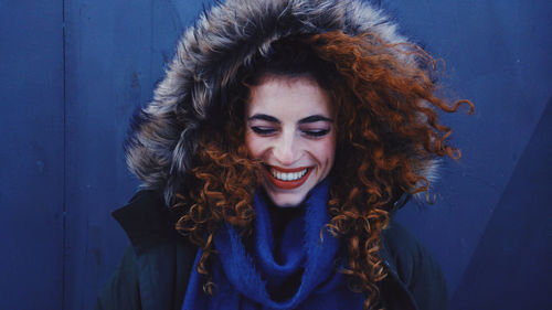 Smiling young woman wearing fur coat