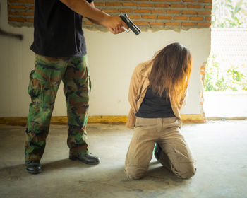 Rear view of man and woman standing on floor