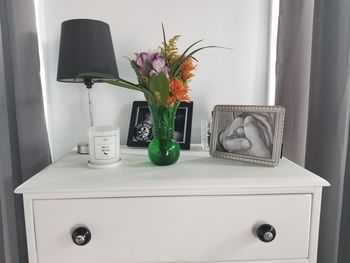 Flower vase on table at home