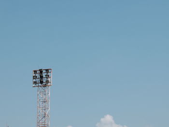 Low angle view of floodlight against blue sky