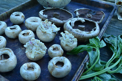 Preparating stuffed white mushroom appetizers for grilling outdoors 