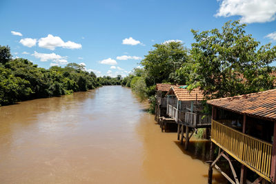 River amidst trees and buildings against sky