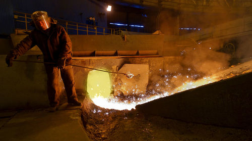 Man working in factory at night