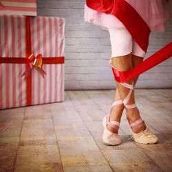 Low section of ballet dancer wrapped in ribbon