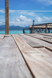 Surface level view of pier on sea against sky