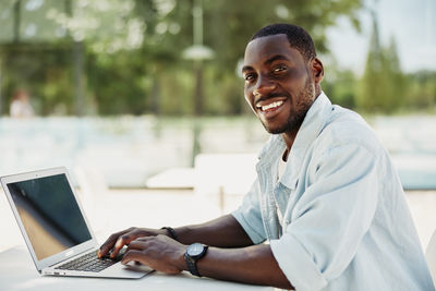 Young man using laptop at office