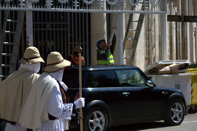 Penitente people walking on street at francavilla fontana