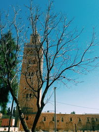 Low angle view of bare tree against clear blue sky